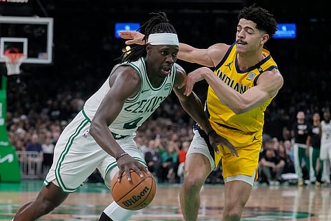 Jrue Holiday drives against Ben Sheppard